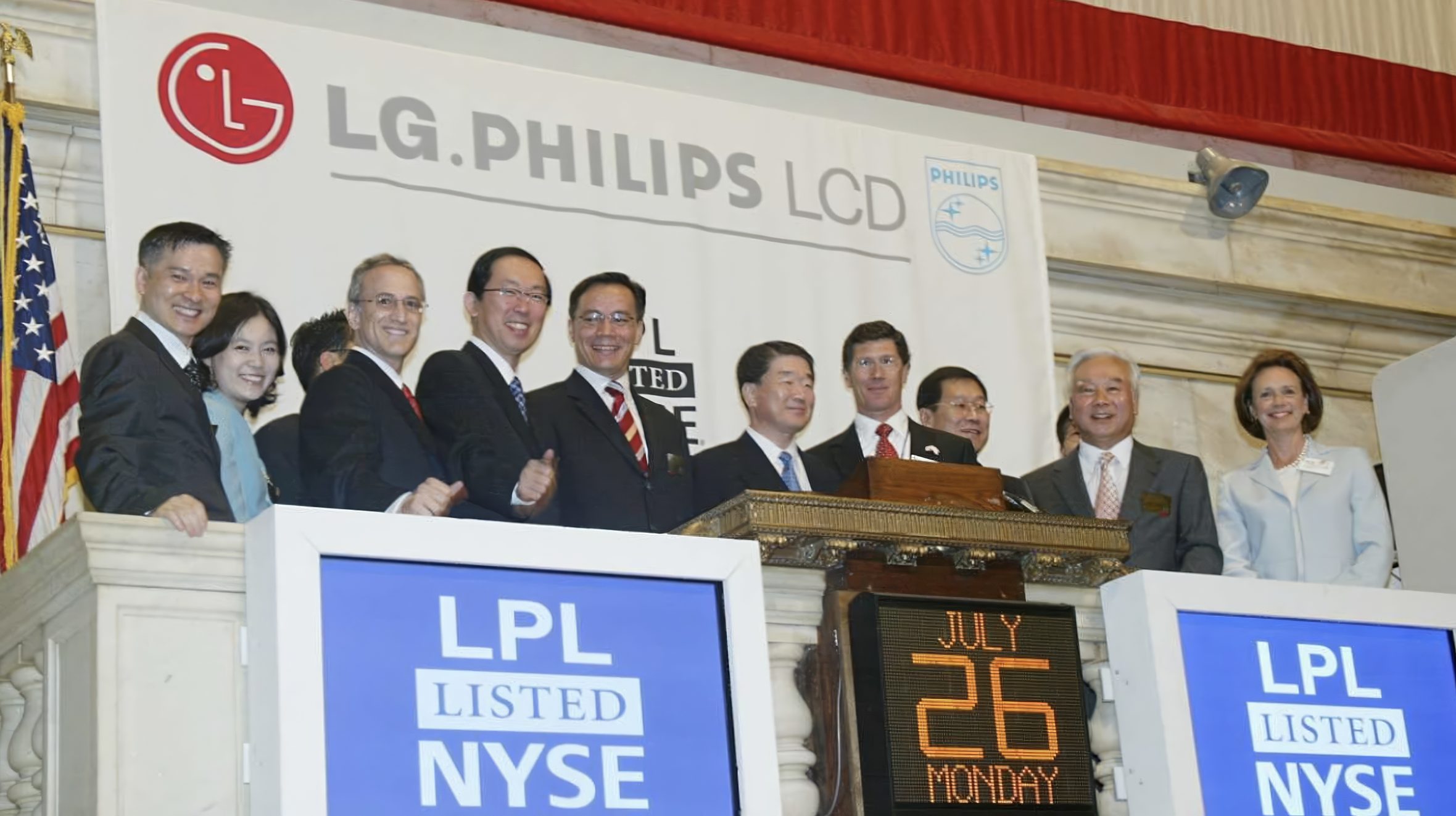 Executives ring the opening bell at the New York Stock Exchange for the LG.Philips LCD listing